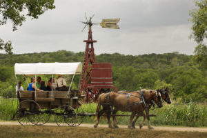 Pioneer Farms in Austin, TX presents Romancing the West® for two shows on Thursday, August 15, 2019 - a 4:00 pm matinee and 7:00 pm evening show. 7/1/12 Ralph Barrera/American-Statesman; Jourdan-Bachman Pioneer Farms, a Living History Park, held an old-fashioned patriotic celebration of Old Glory with horse-drawn wagon rides, live music, artisan vendors, pioneering demos and much more to celebrate Independence Day. Kelly Boesen steers covered wagon rides for visitors with his front seat companion, Rachel Ravencraff, 9, as part of the activities which concluded Sunday. (feature only)